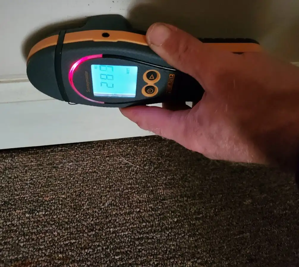 Moisture detection at baseboard during Storm Damage Restoration in Reading
